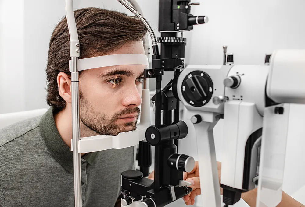 a young man getting an eye exam at the eye doctor's office